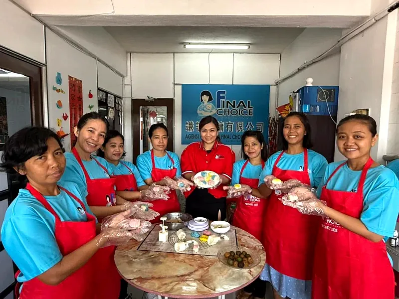 Final Choice domestic helper trainees in branded aprons during a cooking class at the Kuala Lumpur office